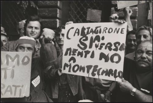 Construction workers hold up protest placards at a demonstration