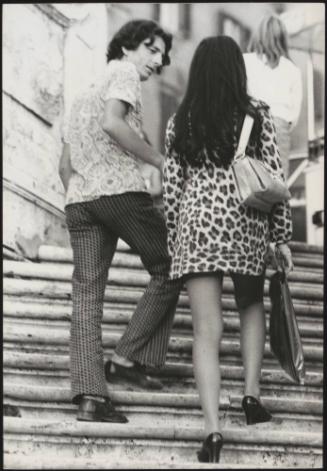 An Italian 'Pappagalli' man tries to talk to a female tourist on the Spanish Steps, Rome