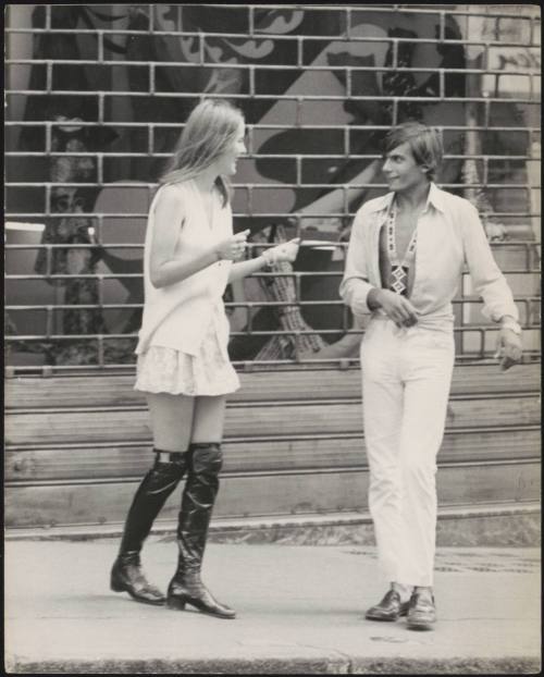 An Italian 'Pappagalli' man approaches a female tourist in the street