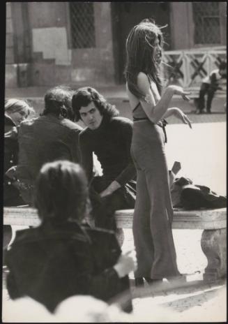 An Italian 'Pappagalli' man waiting to pick up female tourists in Piazza Navona, Rome