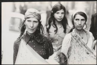 Romani women carrying their children