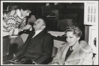 Alessandro Blasetti has final touches done as he sits next to his wife, actress Elisa Cegani 