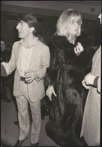 Actors Dustin Hoffman and Monica Vitti socialising at a party