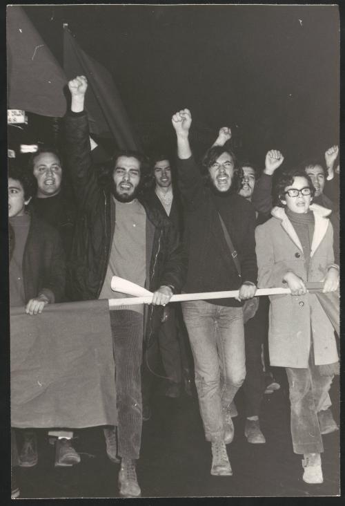 Angry protesters carrying poles and flags during a demonstration march