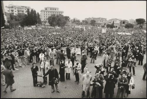 View of a large crowd behind barriers, and press and film crews in front of them, out in support of the Italian Communist party