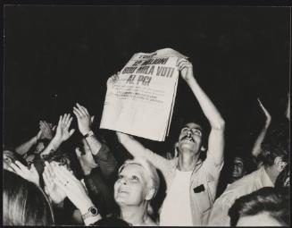 A man holds up a copy of 'L'Unita' whose headline reads - '12 million 600 thousand votes to PCI', dated 23rd June 1976