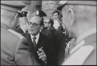 Portrait of a politician greeting Generals