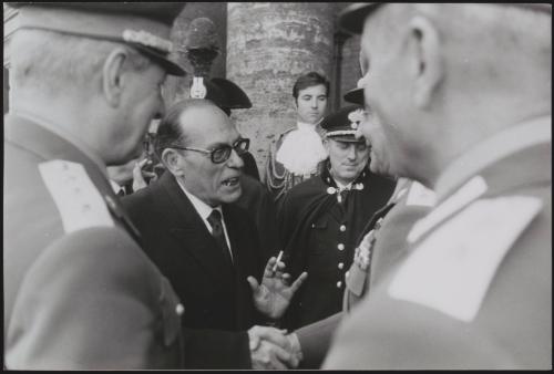 Portrait of a politician greeting Generals