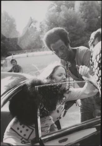 Kenneth Lupper pushes a woman into a car