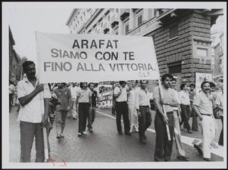 A banner at a demonstration proclaiming solidarity with Palestine's leader, Yasser Arafat