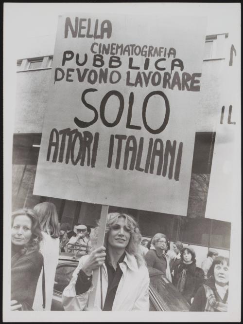 A woman holds a protest placard criticising the casting in Italian cinema 