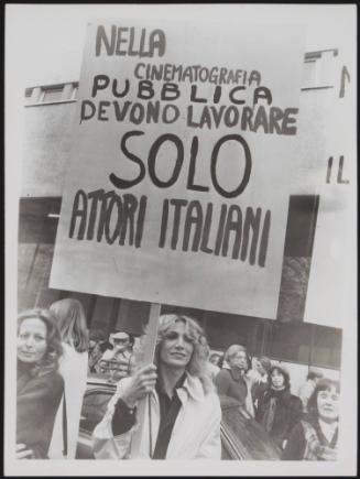 A woman holds a protest placard criticising the casting in Italian cinema 