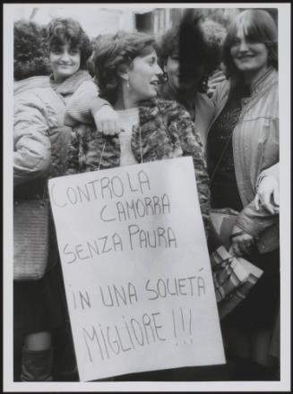 A woman wears a protest placard at an anti Camorra crime syndicate rally
