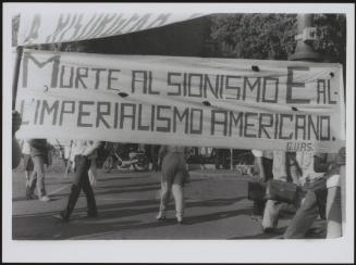 A large banner at a rally: 'Death to Zionism and American imperialism', and G.U.P.S. - the General Union of Palestine Students
