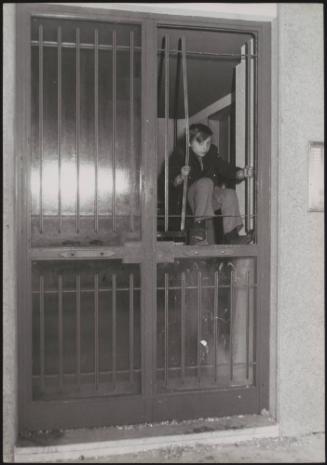 Homeless child climbs through windows into his squat