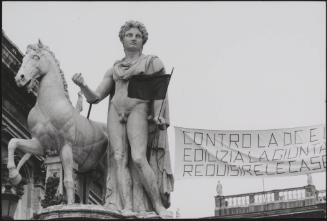 The ancient statue of Castor on the Piazza del Campidoglio in Rome holds one end of a protest banner