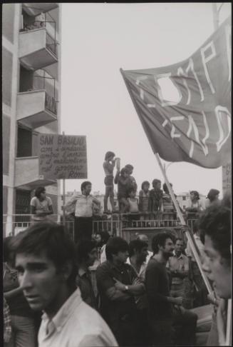 A protest in the San Basilio area of Rome, an area in the north-east of Rome famous for its high levels of crime and poverty. One man's placard says that the area is 'with the unions against the inertia and the immorality of the government in Rome'.