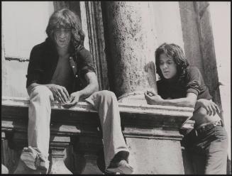 Protesters who have scaled St. Peter's Basilica in the Vatican City watch the response below