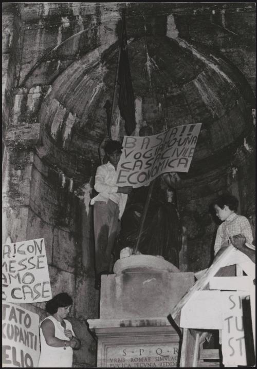 During the rent strikes protesters with banners calling for cheaper home insurance and more economical houses congregate outside a church