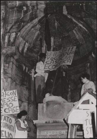 During the rent strikes protesters with banners calling for cheaper home insurance and more economical houses congregate outside a church