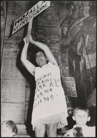 A demonstrator holds a placard reading, 'No to repression!', at a demonstration against forced evictions and rent hikes