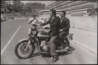Actor Federico Martignoni with club owner Paolo Vassallo on a motorbike during the Number One night club drugs scandal

