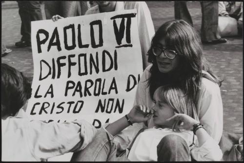 Protesters with a placard criticising Pope Paul VI