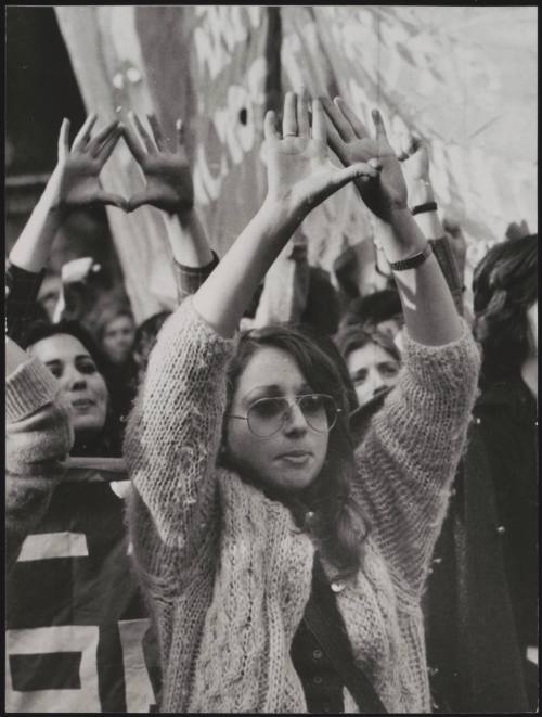Women raise their hands in symbolic solidarity at a meeting for the MLD- Movement for the Liberation of Women