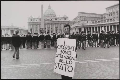 A member of the Radical Party wears a protest placard