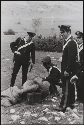 Policemen deal with the aftermath of a gun battle with neo-fascists on L ' Rascino Plateau in which right-wing extremist Giancarlo Esposti was shot dead