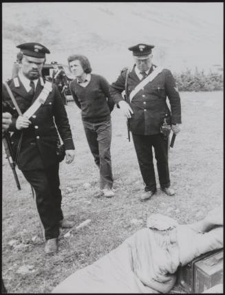 Policemen deal with the aftermath of a gun battle with neo-fascists on L ' Rascino Plateau in which right-wing extremist Giancarlo Esposti was shot dead