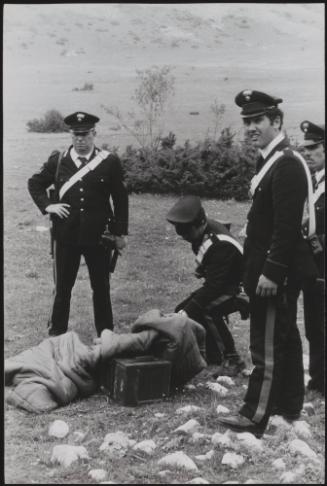 Policemen deal with the aftermath of a gun battle with neo-fascists on L ' Rascino Plateau in which right-wing extremist Giancarlo Esposti was shot dead