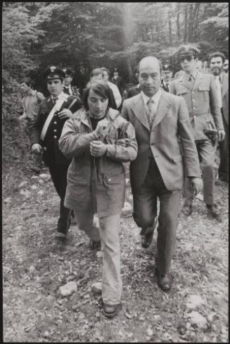 Alessandro D'Intino is led away by policemen in the aftermath of a gun battle between the police and neo-fascists on L ' Rascino Plateau in which right-wing extremist Giancarlo Esposti was shot dead