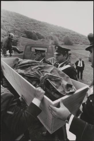Policemen deal with the aftermath of a gun battle with neo-fascists on L ' Rascino Plateau in which right-wing extremist Giancarlo Esposti was shot dead