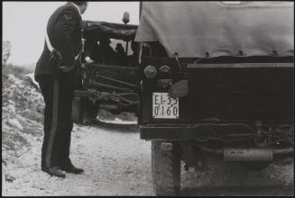 Policemen deal with the aftermath of a gun battle with neo-fascists on L ' Rascino Plateau in which right-wing extremist Giancarlo Esposti was shot dead