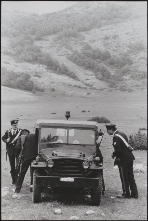 Policemen deal with the aftermath of a gun battle with neo-fascists on L ' Rascino Plateau in which right-wing extremist Giancarlo Esposti was shot dead