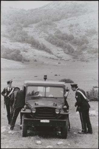 Policemen deal with the aftermath of a gun battle with neo-fascists on L ' Rascino Plateau in which right-wing extremist Giancarlo Esposti was shot dead