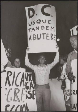 A man holds up a protest placard that reads:
'D.C. usque tandem abutere' (The Christian Democrats abuse) at an anti divorce demonstration