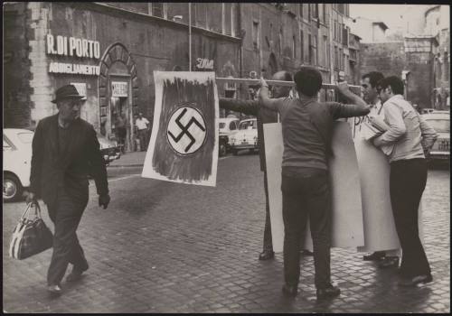 Men holding a Swastika flag in a protest against the pope during the divorce law referendum, Rome