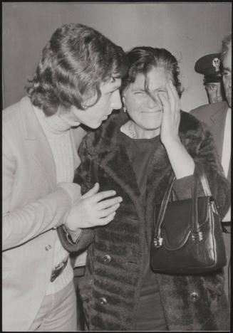 The mother of skyjacker Raffaele Minichiello being comforted by a friend