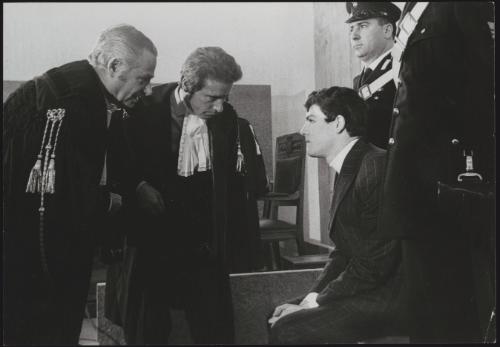 Raphael Minichiello speaks with his lawyers Giuseppe Sotgiu and Edmondo Zappacosta before an appeal for his retrial