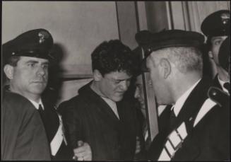 Raphael Minichiello being guarded by Carabinieri in court