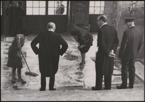 Guards and staff inspect cleaning work on the Egmont Palace grand stairs before the visit of British Prime Minister Harold Macmillan