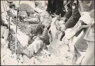 A body trapped is pulled the rubble after buildings collapsed due to the earthquake in Belice, Sicily, which measured 6.4 on the Richter scale