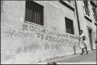 Graffiti on a street wall with a political message against the magistrates who investigated neo-fascist criminal activities (and naming also one of the leaders of the neo-fascists, Saccucci)