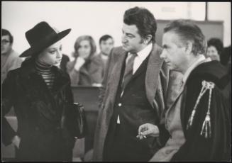 Politician Loris Fortuna watches as a woman confronts a lawyer