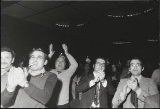 A group of men applauding including Francesco de Martino