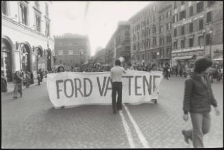 People carrying a banner reading "Ford go away" at an anti-President Ford demonstration in Rome