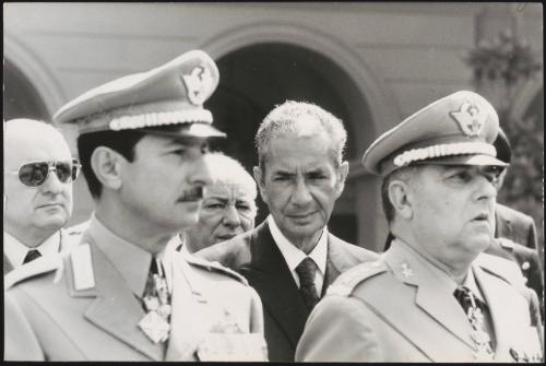 Aldo Moro stands behind a line of Generals