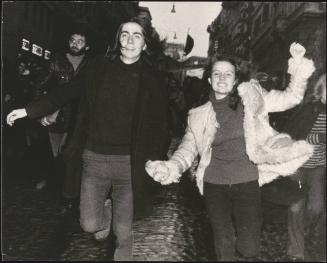 Anarchist demonstrators running hand-in-hand